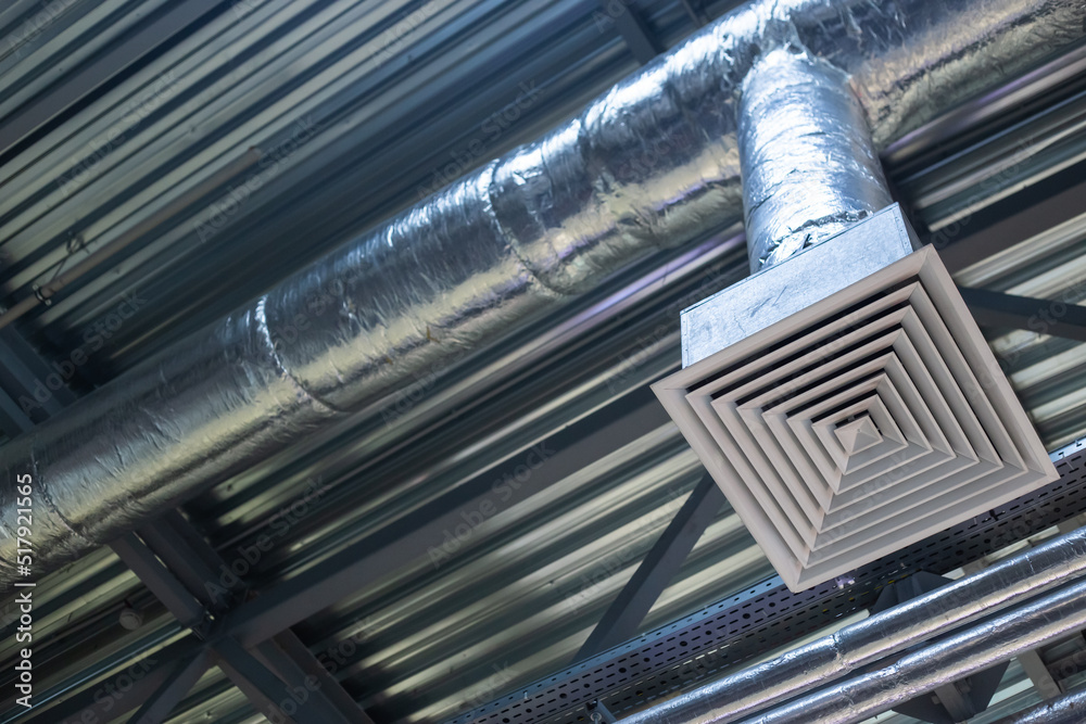 Obraz premium Supply grille for industrial ventilation in an office building under the ceiling, hvac engineering communications
