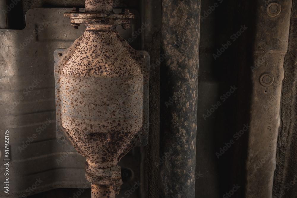 Close-up of Catalytic Converter in Car Exhaust System. The concept of preserving ecology, reducing harmful emissions into the air. legal regulations for vehicles with internal combustion engines