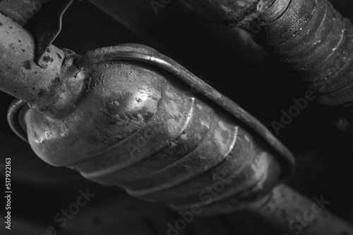 Close-up of Catalytic Converter in Car Exhaust System. The concept of preserving ecology, reducing harmful emissions into the air. legal regulations for vehicles with internal combustion engines