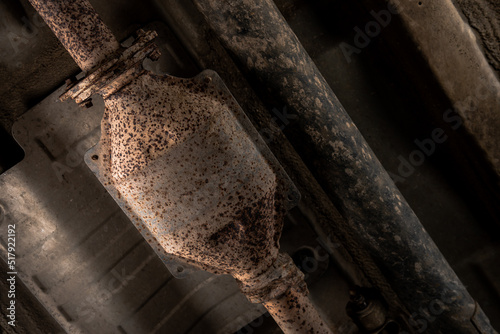 Close-up of Catalytic Converter in Car Exhaust System. The concept of preserving ecology, reducing harmful emissions into the air. legal regulations for vehicles with internal combustion engines