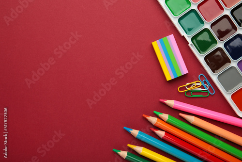 Different stationery on red background, flat lay with space for text. Back to school