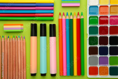 School supplies on green background. Top view.