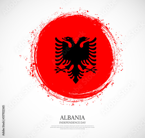 Creative circular grungy shape brush stroke flag of Albania on a solid background