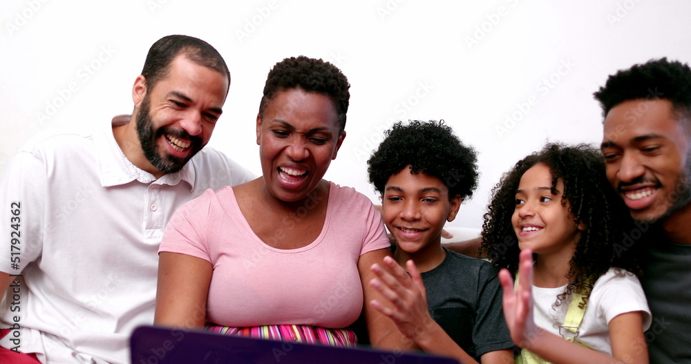 Obraz premium Happy African family talking to relatives on laptop computer