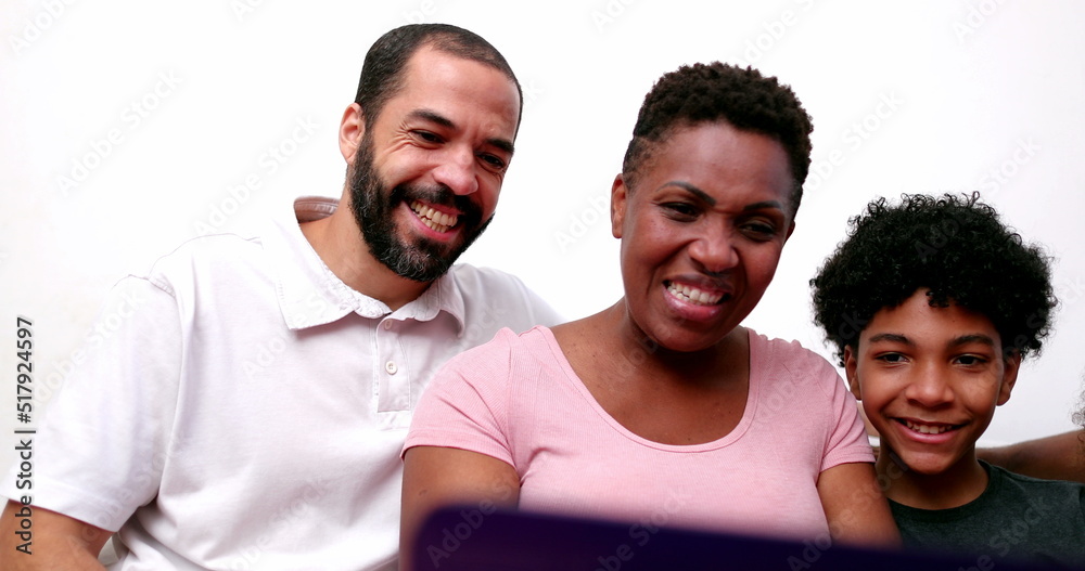 Obraz premium Happy African family talking to relatives on laptop computer