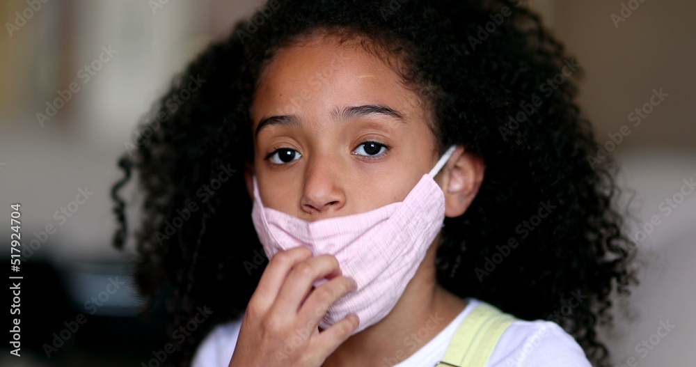 Girl removing covid face mask, little child takes off mask Girl removing covid face mask, little child takes off mask