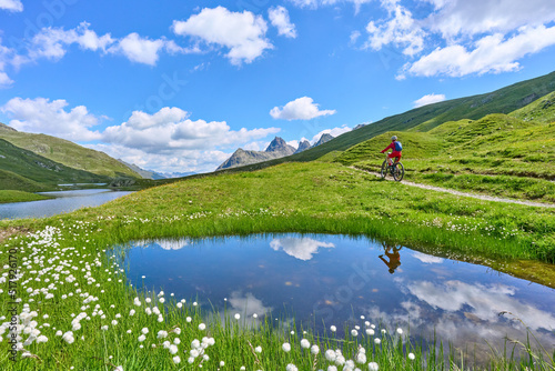 nice active senior woman riding her electric mountain bike in the silvretta mountain range near Gaschurn, Tyrol, Austria © Uwe