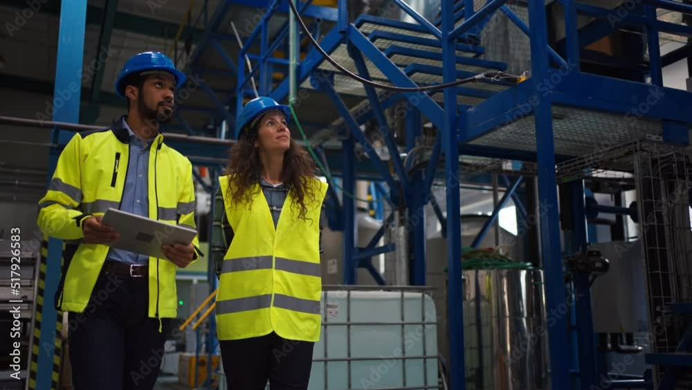 Female chief engineer in modern industrial factory looking at camera, close-up Female chief engineer in modern industrial factory looking at camera, close-up