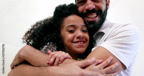 Father embracing daughter child. Interracial parent and child relationship