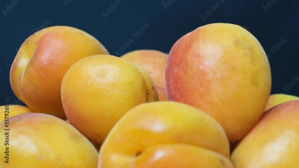 Lots of ripe apricots swirling on a black background, summer seasonal fruits in motion. Lots of ripe apricots swirling on a black background, summer seasonal fruits in motion.