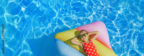 Child in swimming pool. Having fun on vacation at the hotel pool. Colorful vacation concept. photo
