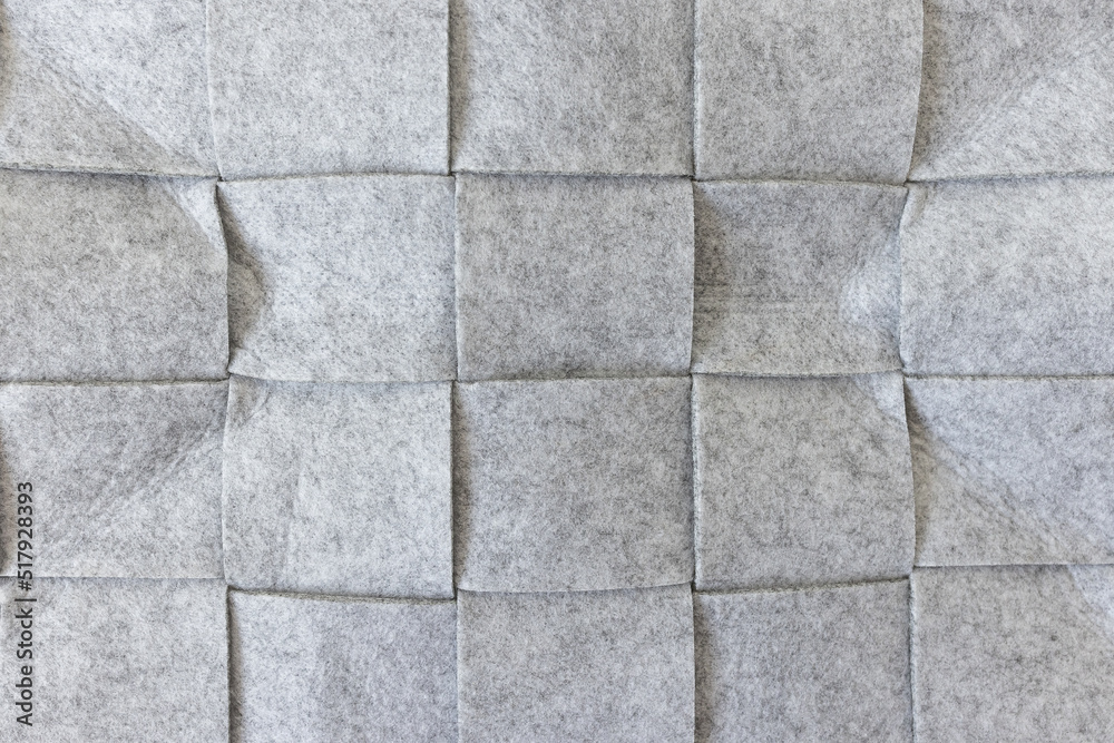 Abstract gray felt background. Home storage basket made of soft grey felt material. Surface of felted wool fabric texture. Close-up, square pattern Abstract gray felt background. Home storage basket made of soft grey felt material. Surface of felted wool fabric texture. Close-up, square pattern