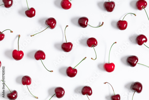 Red cherry on white background. Ripe red cherry berries as background. Flat lay, top view, copy space