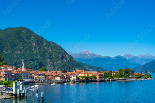 The town of Menaggio with its lakefront, its buildings, and the pier. 