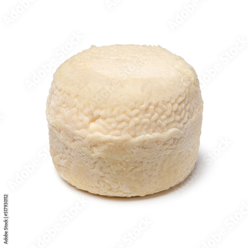 Single traditional small whole goat cheese isolated on white background close up