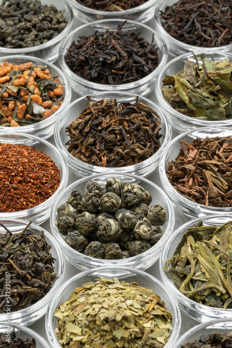 Glas bowls with a variaton of different dried tea leaves close up full frame as background photo