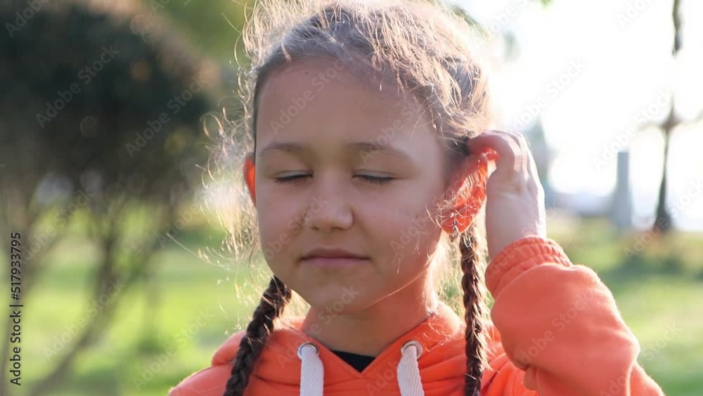 Portrait of teenager girl is smiling and adjusting her hair while looking at camera, 4k video Portrait of teenager girl is smiling and adjusting her hair while looking at camera, 4k video