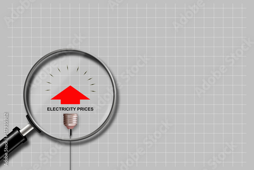 Rising electricity prices. A light bulb and a graph with an up arrow, on a grey background. Magnifying glass. World crisis. Business.