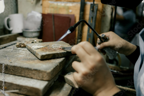 Jeweler at work in jewelry. Desktop for craft jewelry making with professional tools. Close up view of tools. Silver jewelry. Unique local artwork in Nan Province northern thailand