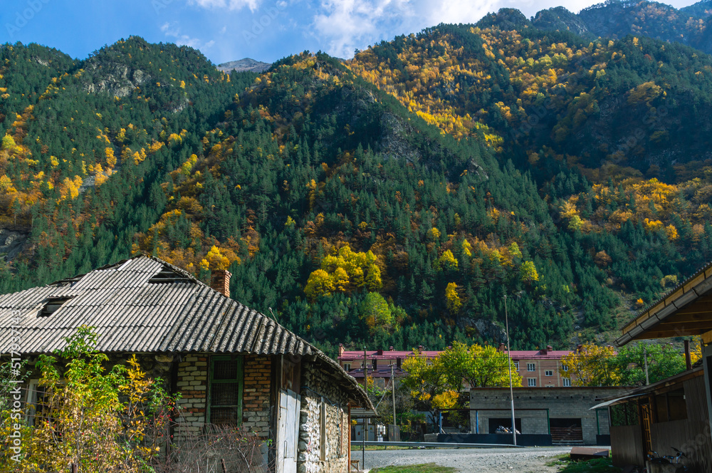 A village in the mountains. Roofs of houses in a mountain village. Autumn landscape in a mountainous area.