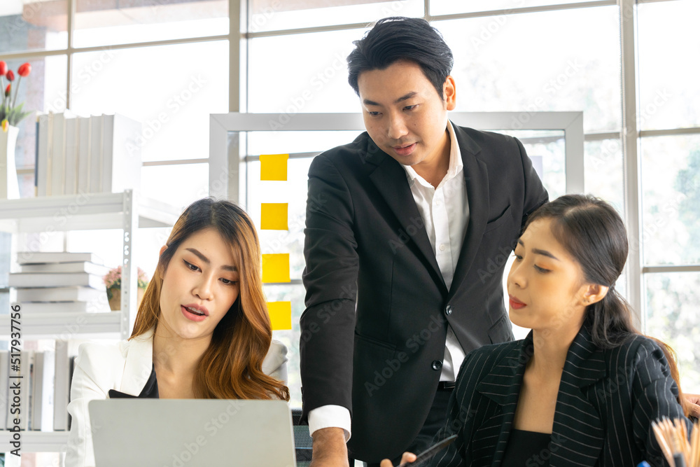 A group of young Asian businessmen Talking and planning work happily and have fun. at the company's office A group of young Asian businessmen Talking and planning work happily and have fun. at the company's office
