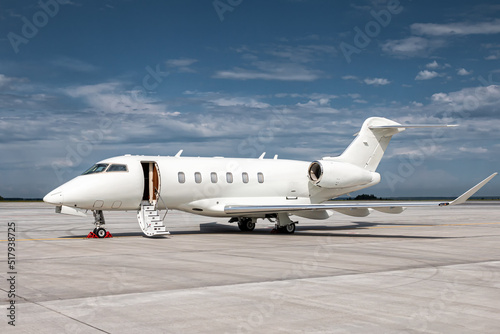 Obraz na plátně Modern white corporate business jet with a lowered gangway door at the airport a