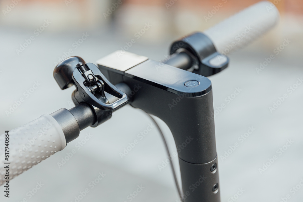 Electric scooter handle bar with smart display on grey background Electric scooter handle bar with smart display on grey background