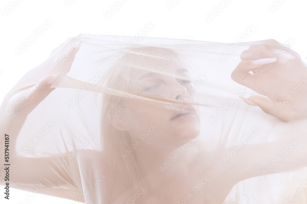 Naklejka premium Young tender beautiful girl under transparent fabric, cloth isolated on white studio background. Grace, art, beauty, contemp dance, ad concept. Monochrome