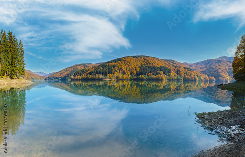 Vilshany water reservoir on the Tereblya river, Transcarpathia, Ukraine. Picturesque lake with clouds reflection. Beautiful autumn day in Carpathian Mountains.