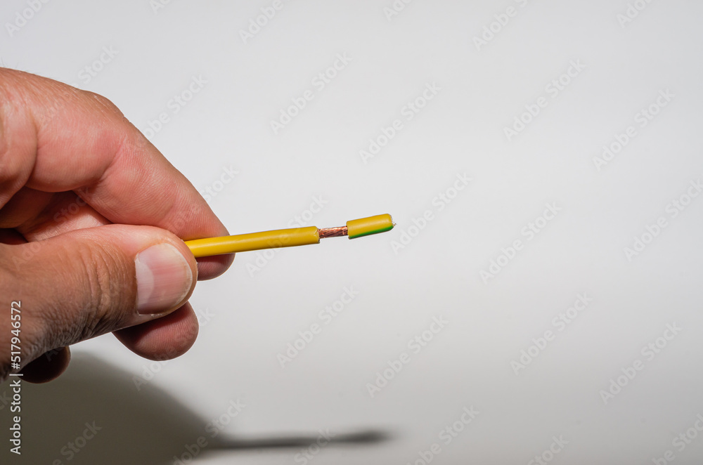Master electrician removes insulation from electrical wiring Master electrician removes insulation from electrical wiring