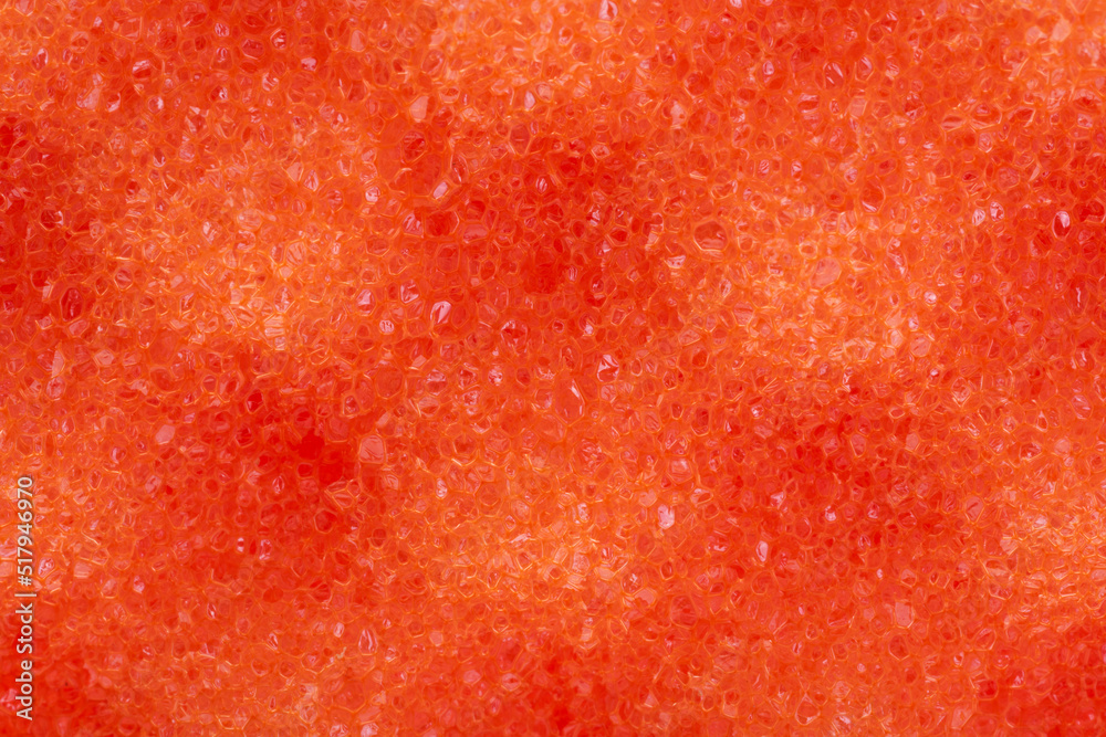 background of orange sponge washcloth closeup