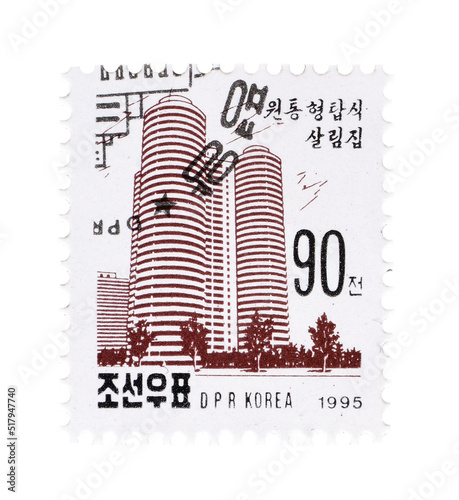 Cancelled postage stamp printed by North Korea, that shows Urban apt. towers, circa 1995. photo