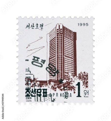 Cancelled postage stamp printed by North Korea, that shows Sosan Hotel, circa 1995. photo