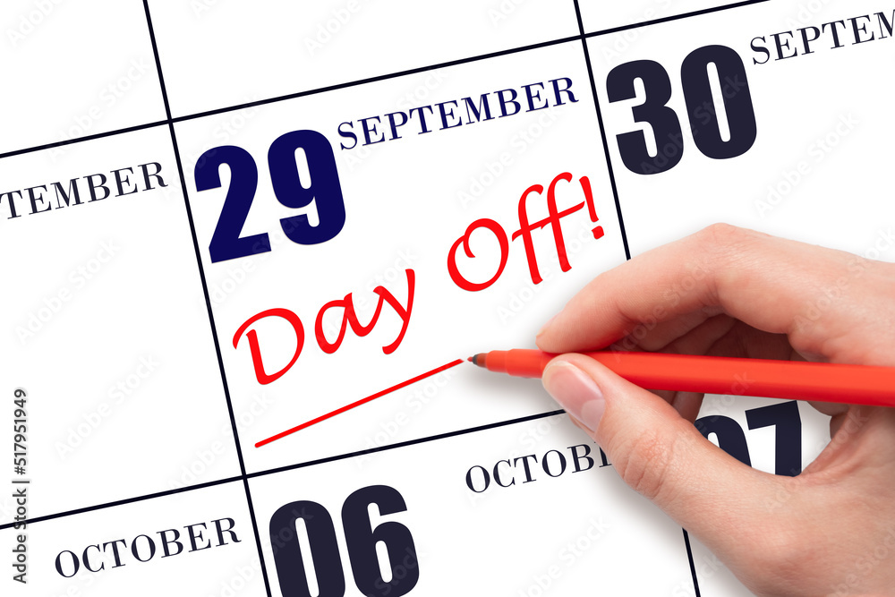 Hand writing text DAY OFF and drawing a line on calendar date 29 September . Vacation planning concept. Hand writing text DAY OFF and drawing a line on calendar date 29 September . Vacation planning concept.