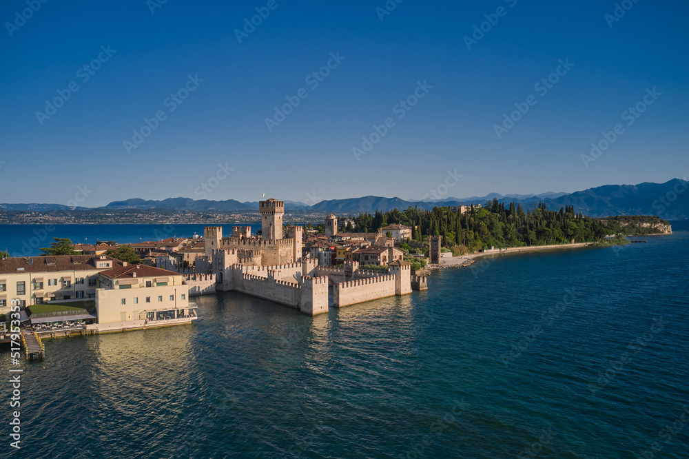 Aerial view of Scaligero Castle at sunrise. Sirmione aerial view on Lake Garda, Italy. Historic Water Castle on Lake Garda.