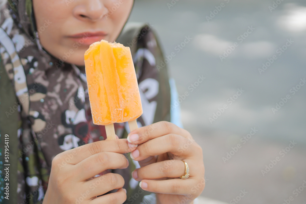 young women eating chocolate flavor ice cream young women eating chocolate flavor ice cream