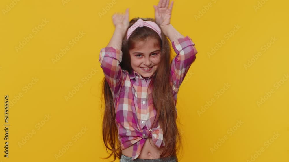 I am little bunny rabbit. Lovely funny young preteen child girl kid smiling friendly and doing bunny ears gesture on head, having fun, fooling with humorous comical mood. Little cute toddler children I am little bunny rabbit. Lovely funny young preteen child girl kid smiling friendly and doing bunny ears gesture on head, having fun, fooling with humorous comical mood. Little cute toddler children