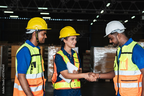 Group warehouse workers shake hands to celebrate and be happy in the warehouse., Industrial and industrial concept.