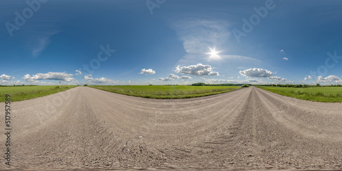 360 hdri panorama on no traffic gravel dusty road among fields with fluffy clouds in full seamless spherical equirectangular projection, may use like sky replacement for drone panorama