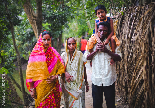 South asian family picture . happy bangladeshi hindu family in a village outdoor environment. 
