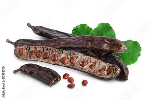 Ripe carob pods and bean isolated on white background with full depth of field photo