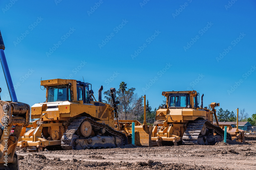 Construction machinery. A bulldozer and an excavator are clearing the construction site. Construction machinery. A bulldozer and an excavator are clearing the construction site.