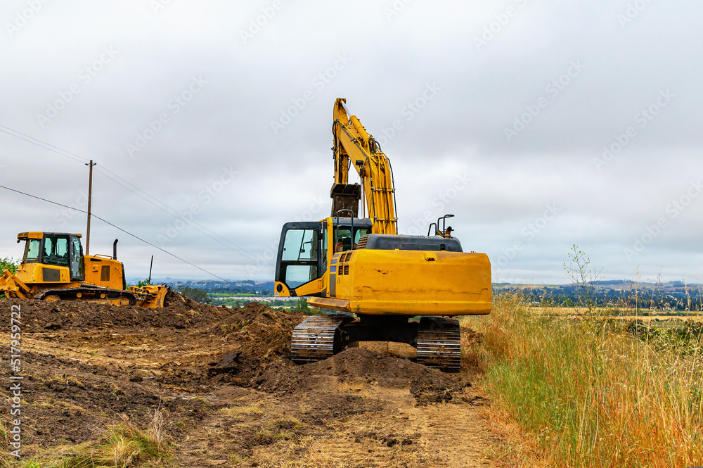 Construction machinery. A bulldozer and an excavator are clearing the construction site. Construction machinery. A bulldozer and an excavator are clearing the construction site.