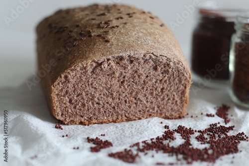 Ragi bread or Finger millet bread. Loaf of home baked bread with finger millet flour sprinkled with fax seeds on top. photo