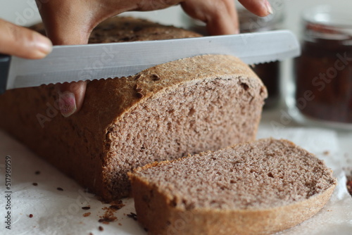 Ragi bread or Finger millet bread. Loaf of home baked bread with finger millet flour sprinkled with fax seeds on top.