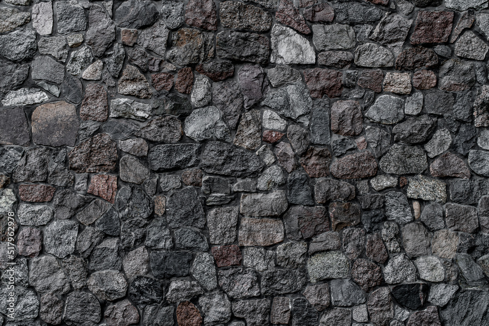 horizontal view of wall with masonry of various stones. Background and texture of stone wall surface horizontal view of wall with masonry of various stones. Background and texture of stone wall surface