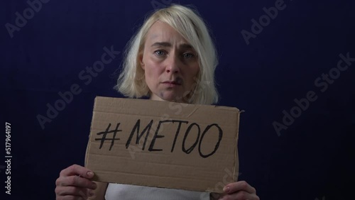 Bruises on the woman's face. A woman holds a placard with the text METOO.