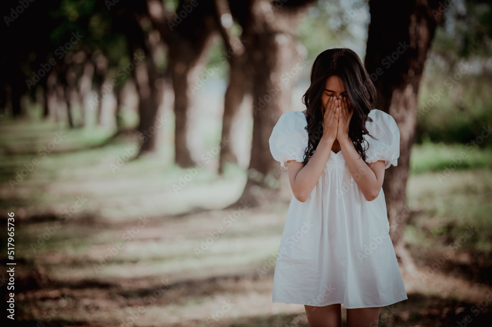 Naklejka premium Asian beautiful girl feel alone in the forest,Sad woman concept,Thailand people,Lady sadness about love from boyfriend,She feeling broken heart