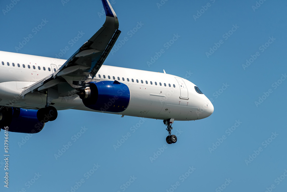 Close-up of modern airplane over blue sky Close-up of modern airplane over blue sky