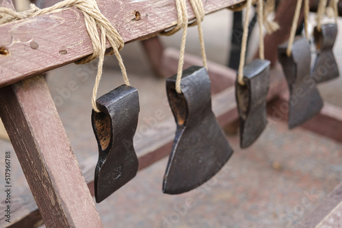 Axes of different sizes for carpentry of past years, handmade with an axe, an exhibition of tools photo